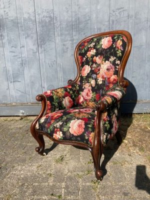 Antieke armstoel met bloemmotief stof, elegante uitstraling, perfect voor interieur decoratie.