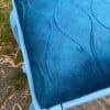 Blauw gestikt stoffenkussen voor stoel, kleurrijk en comfortabel interieurdecoratie.