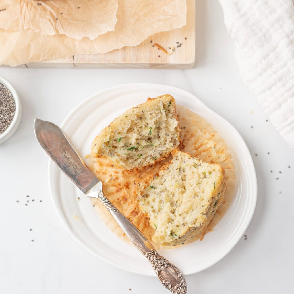 Gluten Free Zucchini Chia Muffin cut in half on a small plate.