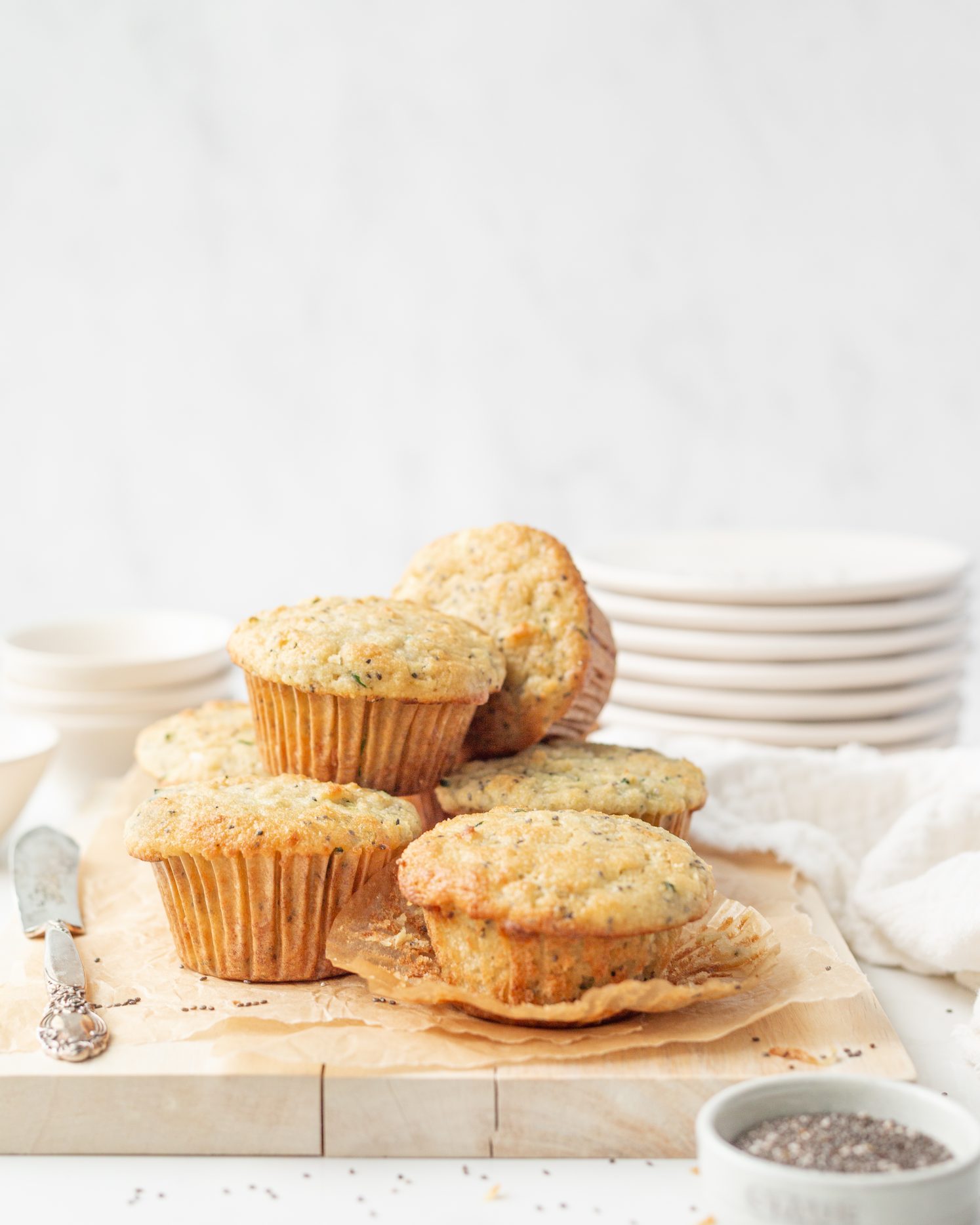 Gluten Free Zucchini Chia Muffins styled on parchment paper.