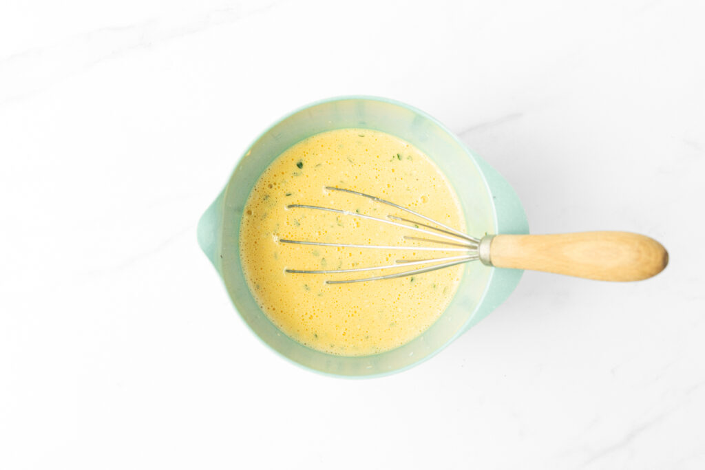 Process shot #2: Eggs, cream, fresh thyme, Emmental cheese, salt and pepper whisked in a small mixing bowl.