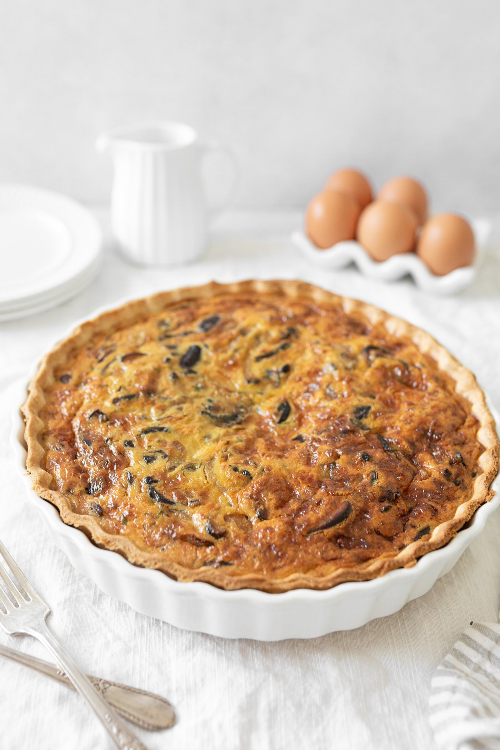 Caramelized Onion and Mushroom Quiche baked in a dish.