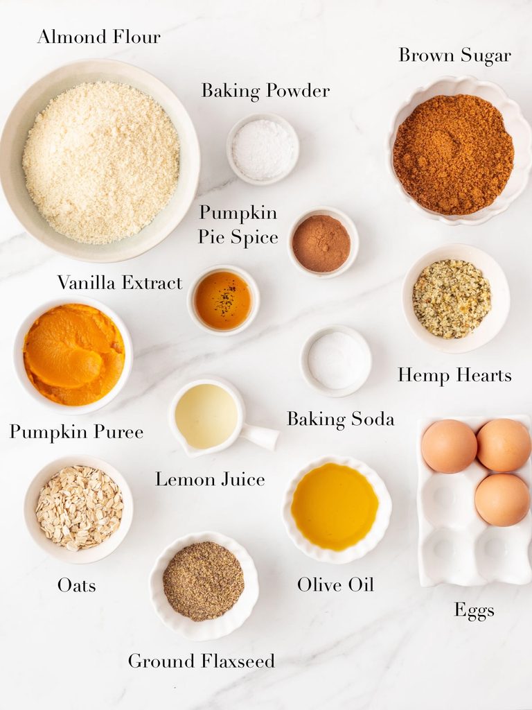 Ingredients for Gluten Free Pumpkin Bread portioned out into bowls on a marble slab. 
