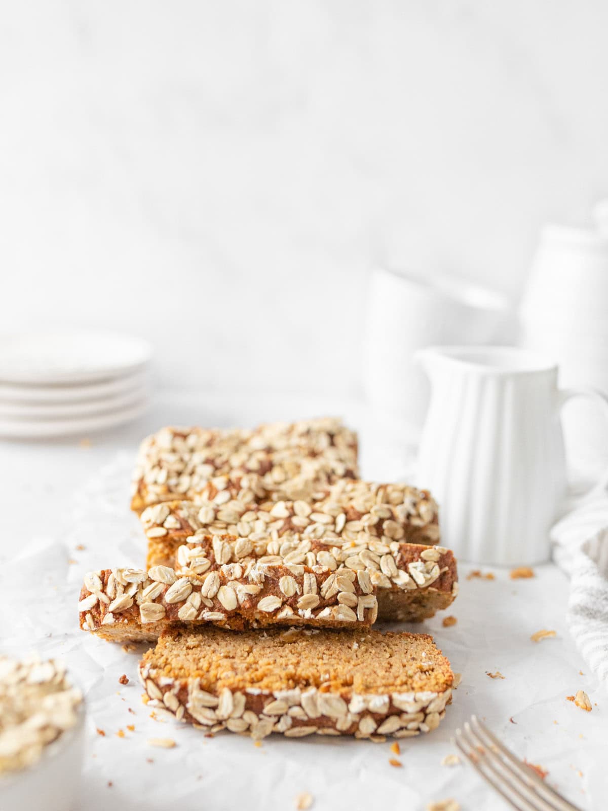 Gluten Free Pumpkin Bread sliced and layered on parchment paper. 