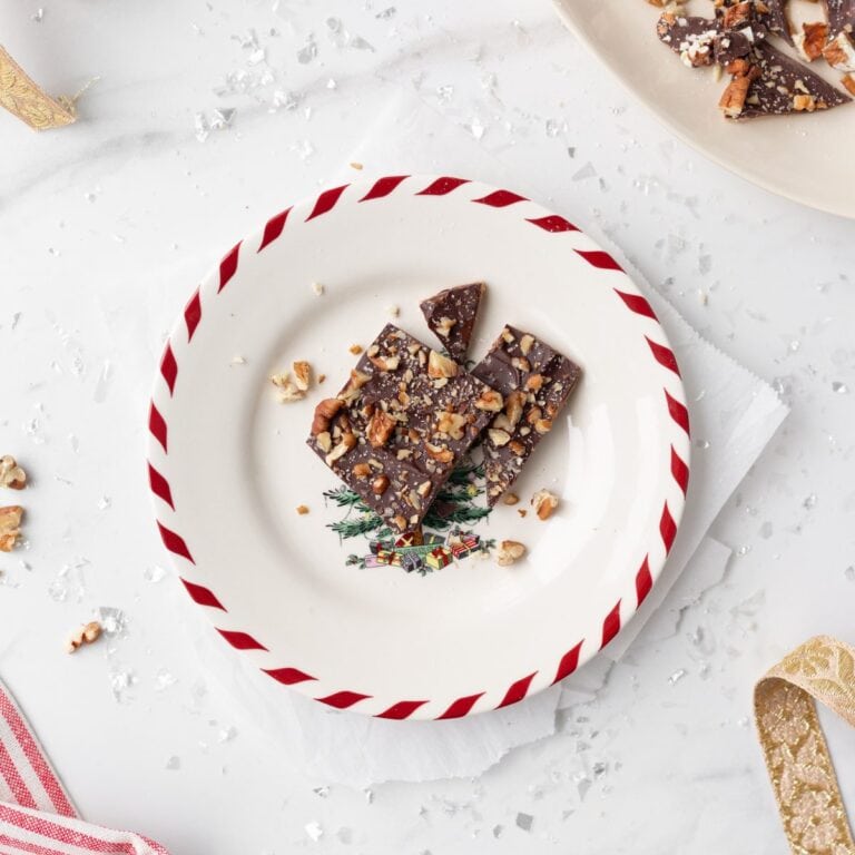 Chocolate Almond Toffee Bark broken up and served on a Christmas plate.
