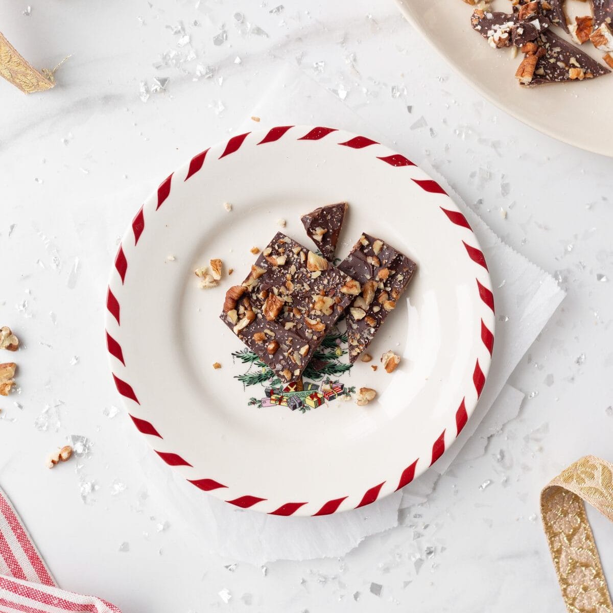 Chocolate Almond Toffee Bark broken up and served on a Christmas plate.