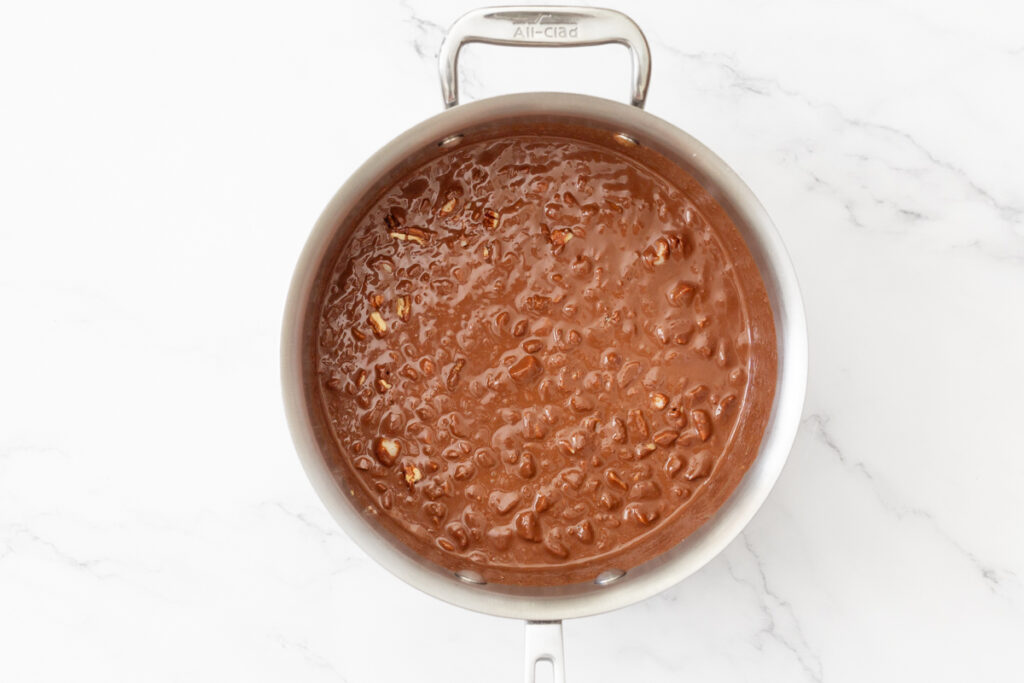 Process shot #2: chopped nuts added to the same saucepan with the melted chocolate in it.