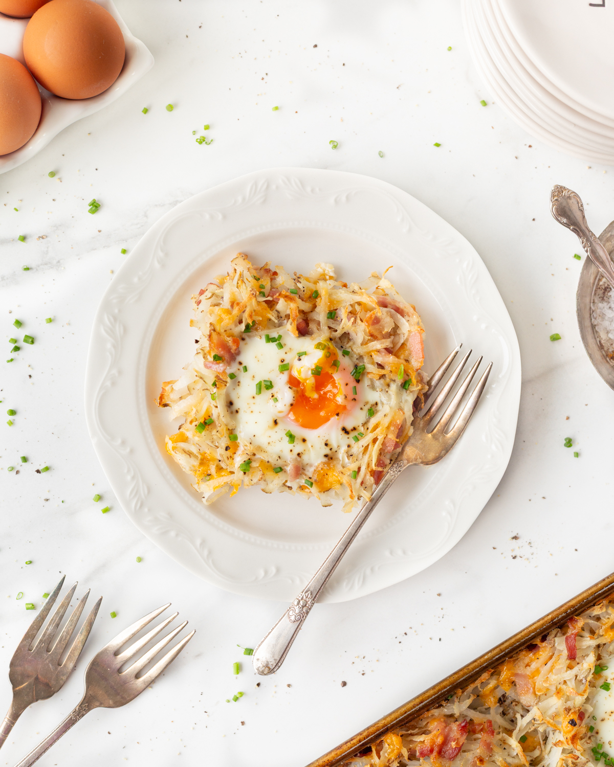 Breakfast Egg Nests served on a plate with a fork.