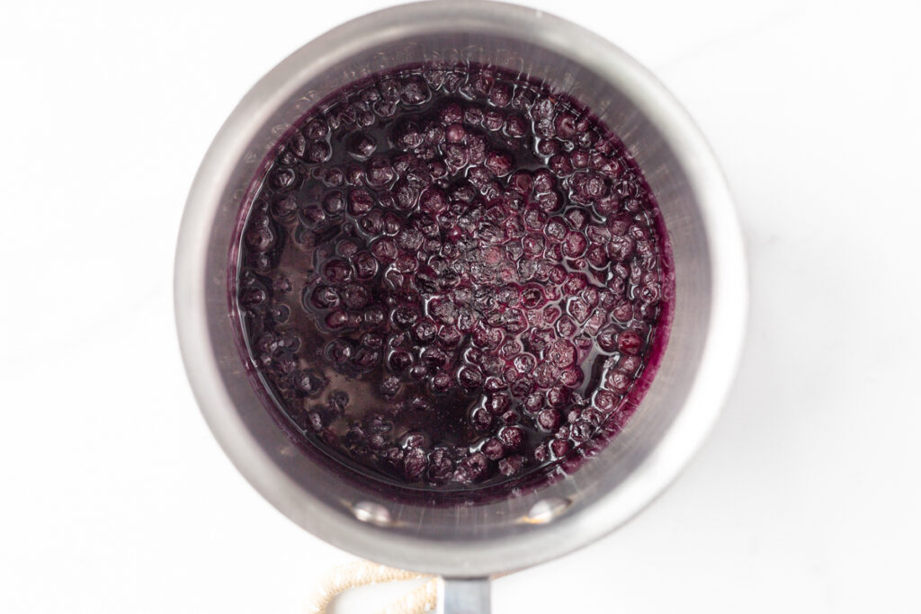 Process shot #1: Blueberry sauce cooked and reduced in a small saucepan.