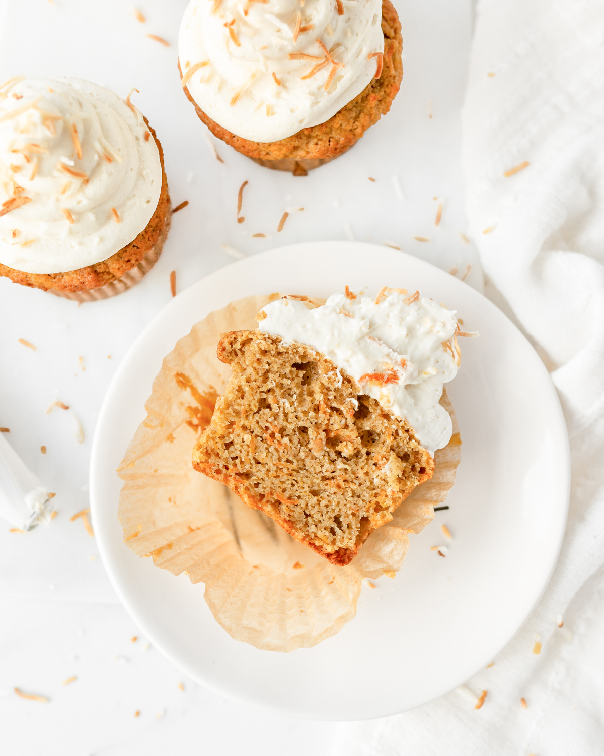 1 Gluten Free Carrot Cupcake cut in half on a small plate.