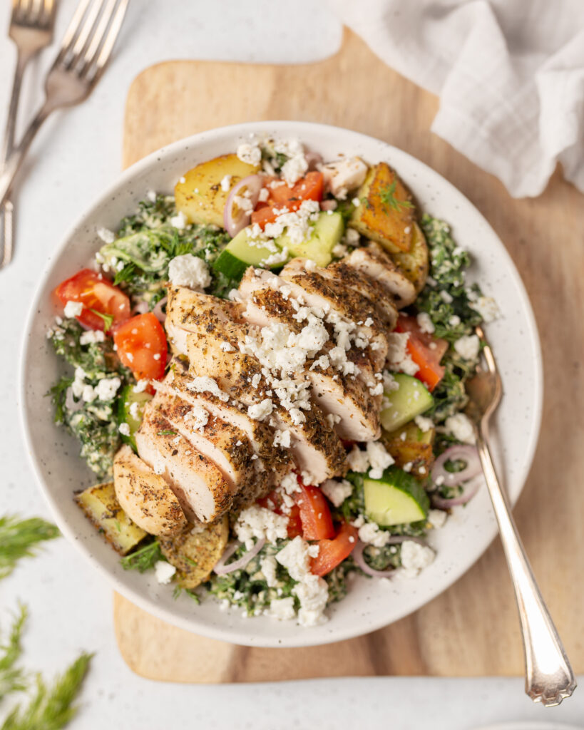 Mediterranean Chicken Salad with creamy hummus dressing plated and topped with goat feta.