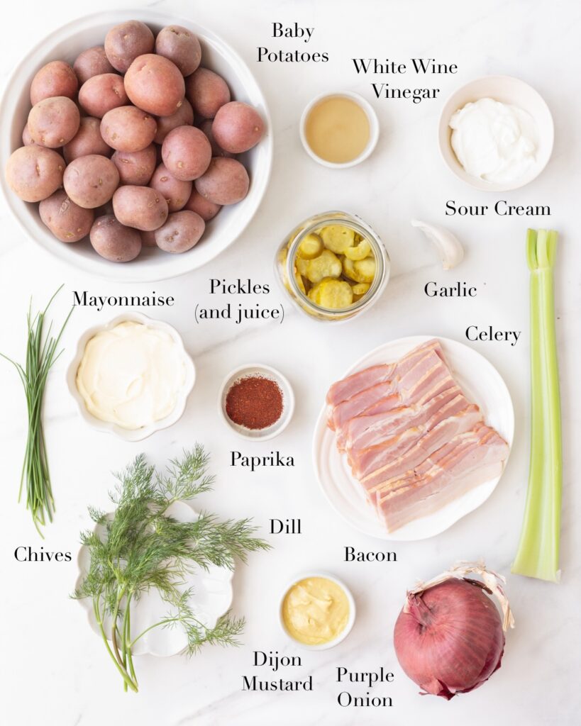 Ingredients for Potato Salad with Creamy Herb Dressing portioned out on a marble slab.