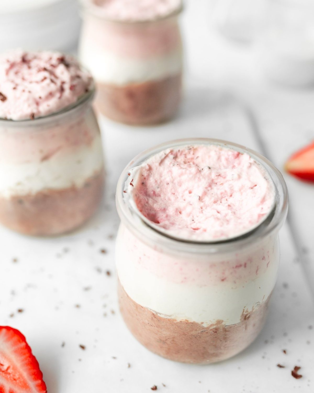 Neapolitan Mousse in small jars garnished with chocolate shavings.