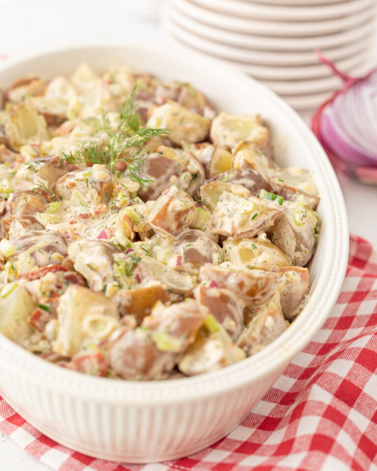 Homemade Summer Potato Salad served in a dish and topped with fresh dill.