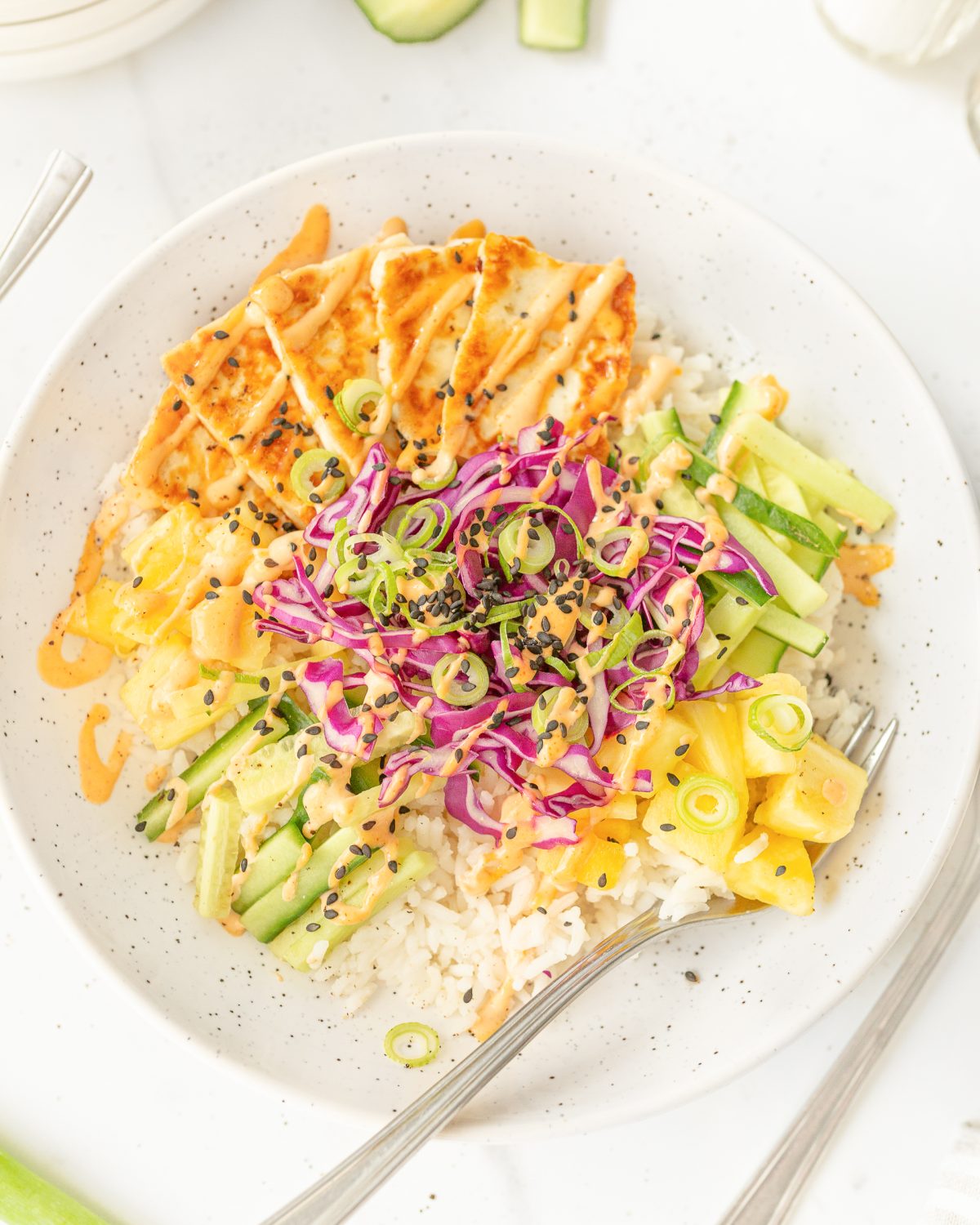 Halloumi Bowl plated and garnished with black sesame seeds.