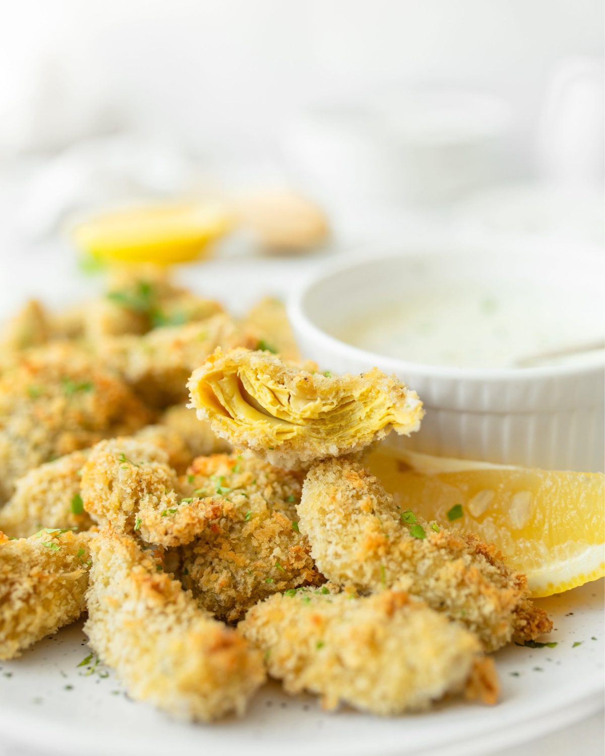 Crispy Oven-baked Artichoke Hearts with Lemon Herb Dip cut in half.