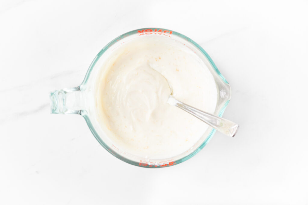 Process shot #1: Plain greek yogurt and honey mixed together in a large glass measuring cup.