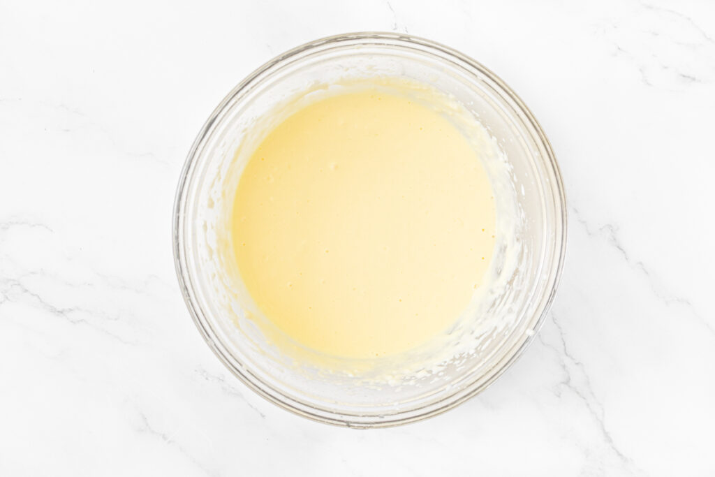 Process shot #1: Wet ingredients for gluten free key lime cupcakes mixed in a medium-sized, glass mixing bowl. 