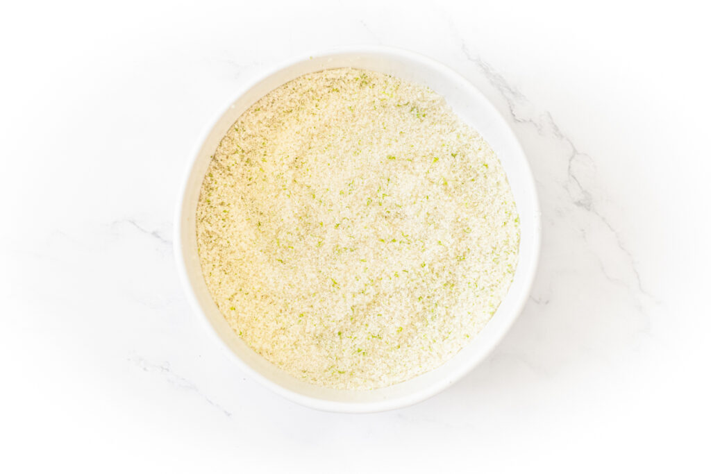 Process shot #2: Granulated sugar and lime zest rubbed together in a small bowl. 