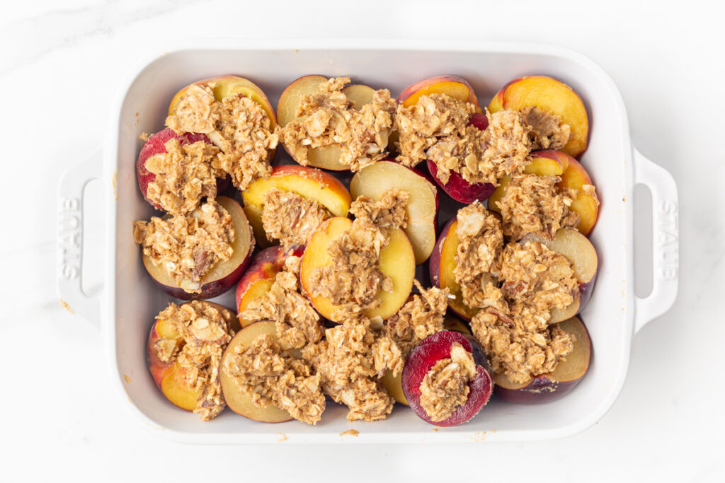 Process shot #4: Stone fruits in a baking dish topped with oat crumble; ready to be baked!