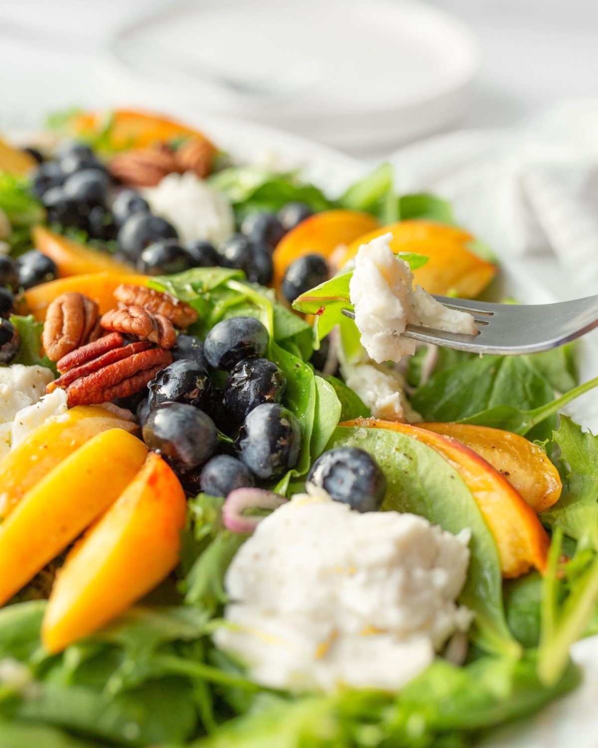 Salad and mozzarella on a fork.