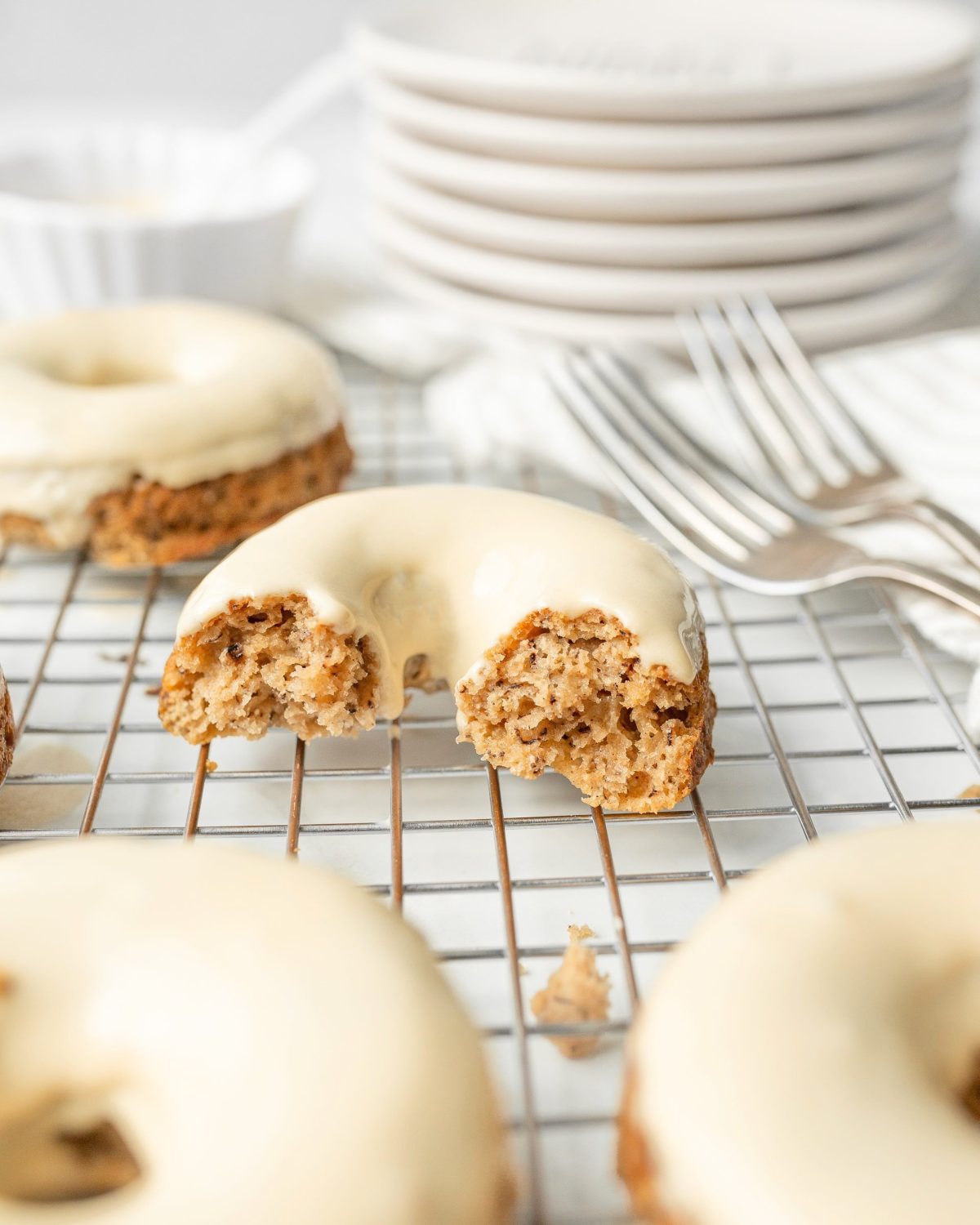 GF Banana Bread Donuts with Maple Glaze cut in half.