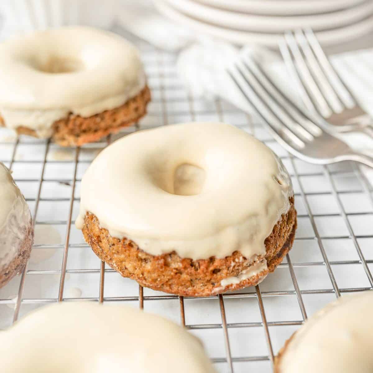 Gluten Free Banana Bread Donuts dipped in maple glaze.