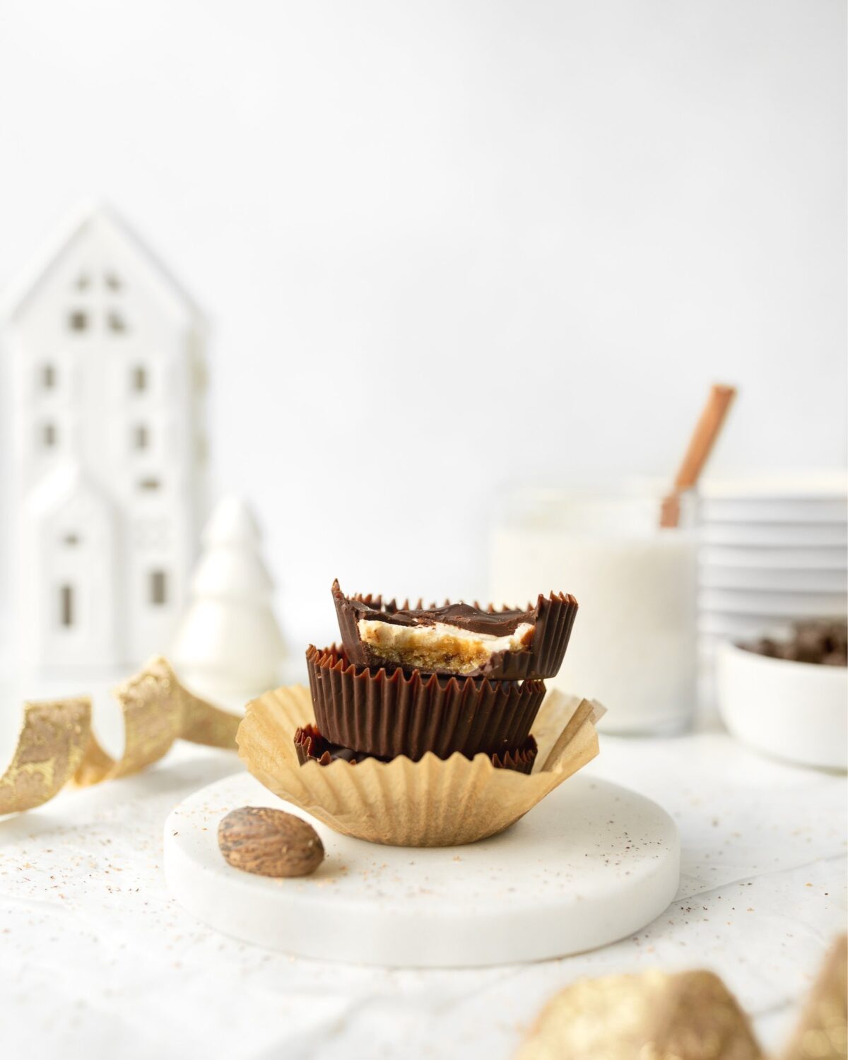 3 Chocolate Covered Eggnog Cheesecake Bites stacked on top of each other.