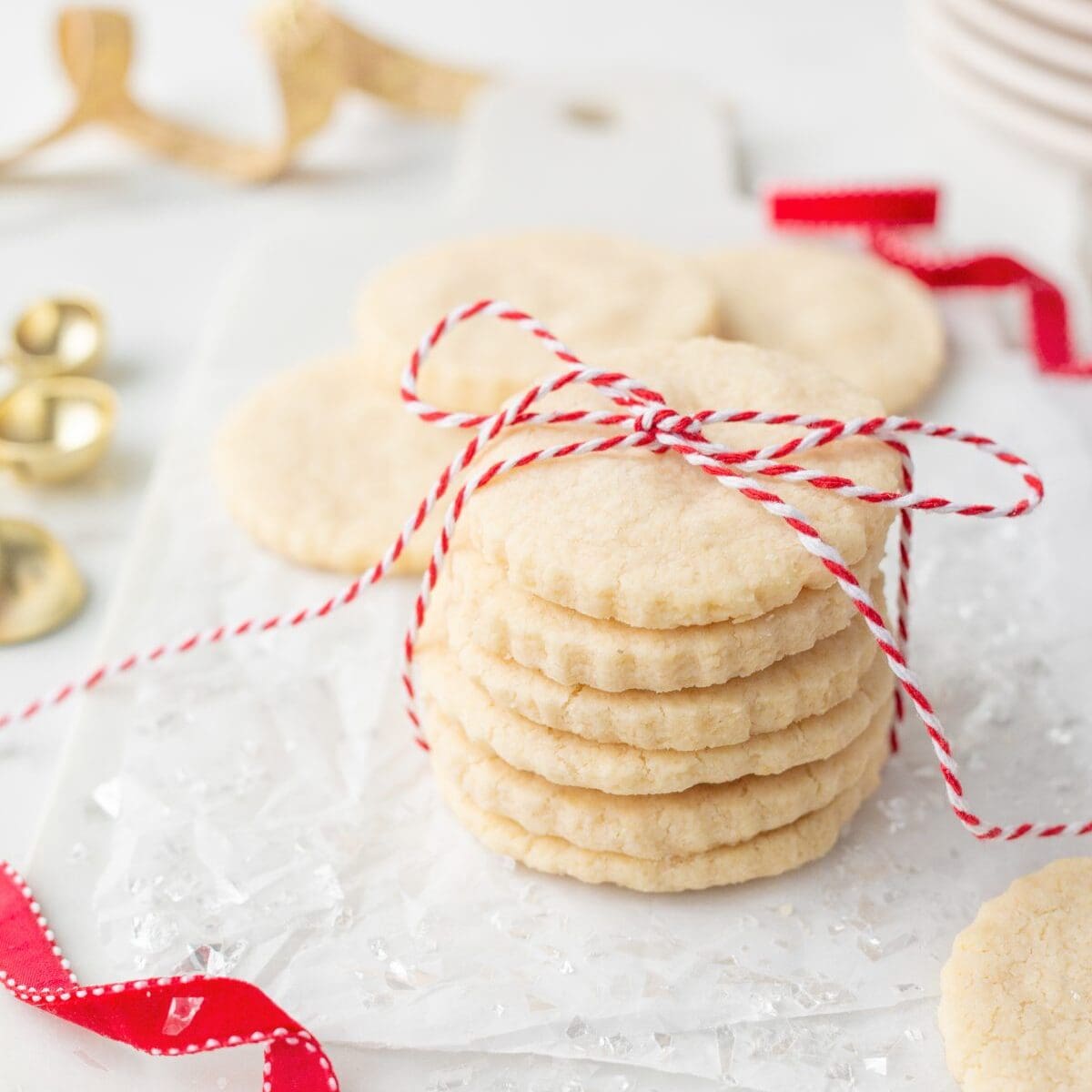 Gluten Free Shortbread Cookies stacked on parchment paper.