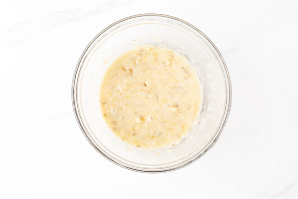 Process shot #1: Mashed bananas and xylitol in a medium-sized glass mixing bowl.