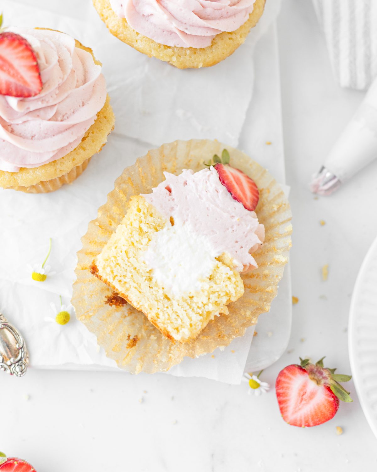 A gluten free Strawberries and Cream Cupcake cut in half (top down)