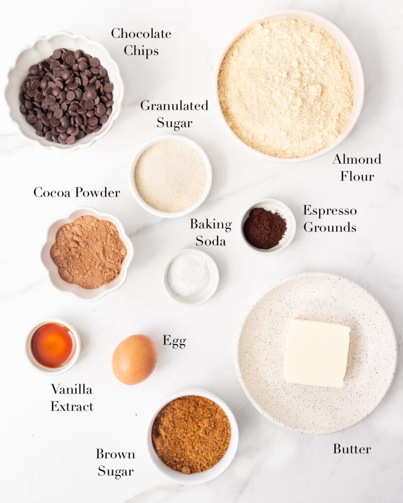 Ingredients for Double Chocolate Cookies portioned out on a marble slab.