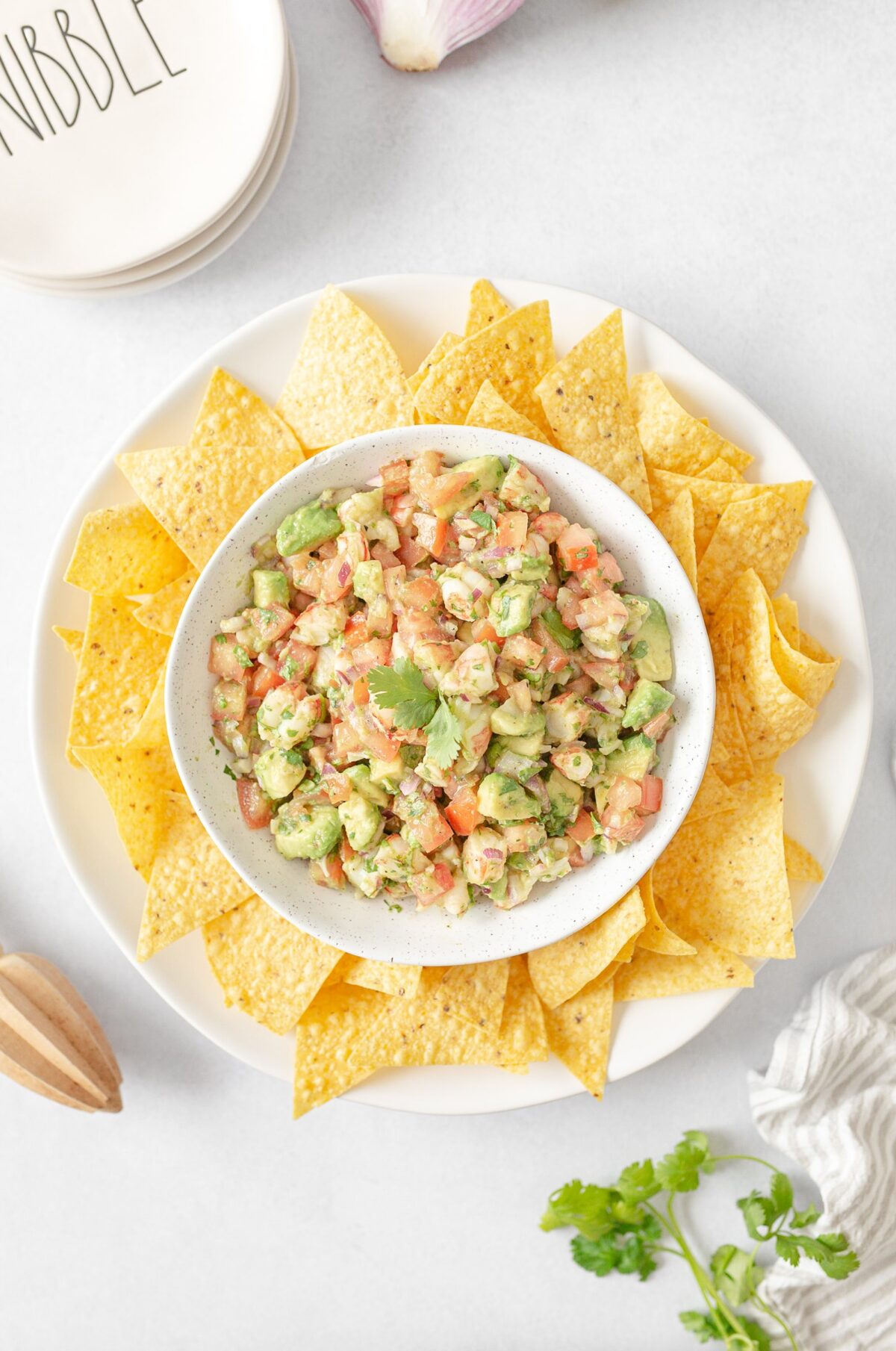 Avocado Shrimp Salsa served in a bowl with tortilla chips on the side.