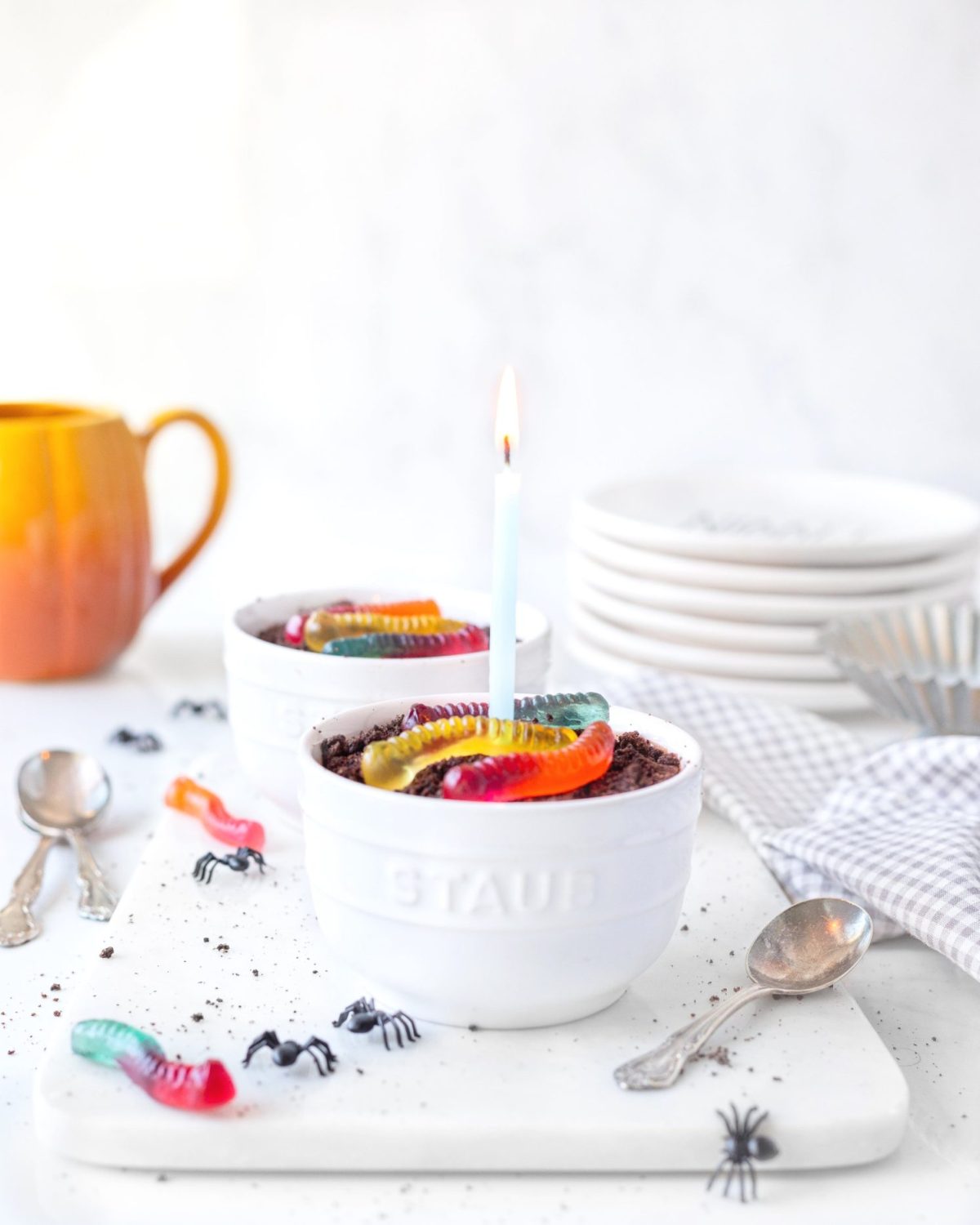 Gluten Free Worms and Dirt in a bowl with a lit candle in the centre.