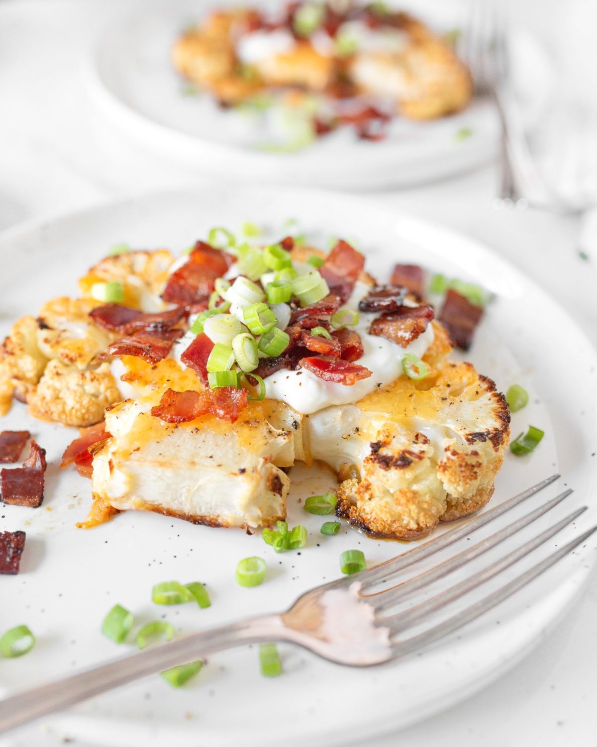 Loaded Baked Cauliflower Steaks assembled and plated.