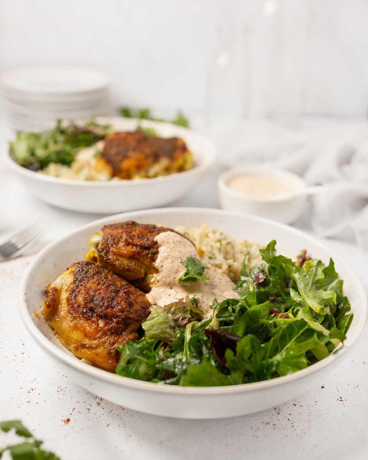 Baked Tandoori Chicken Thighs plated with Cilantro Rice and a green salad.