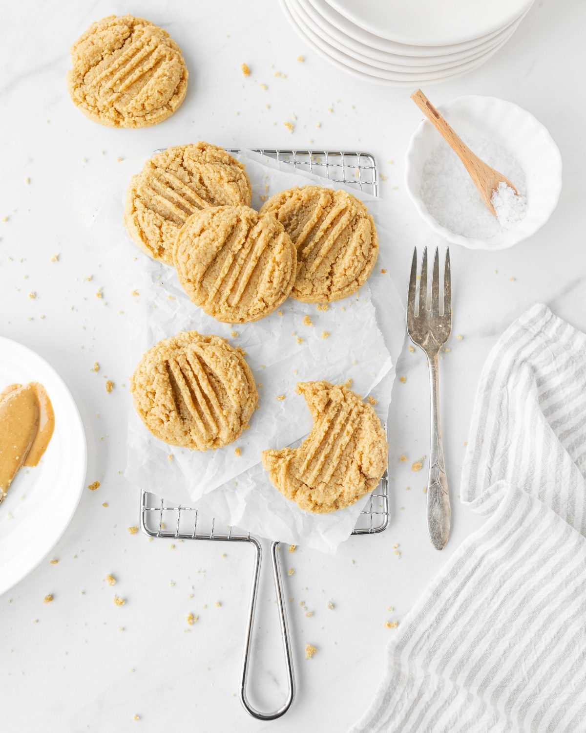 Chewy Gluten Free Peanut Butter Cookies on parchment paper on top of a cooling rack.