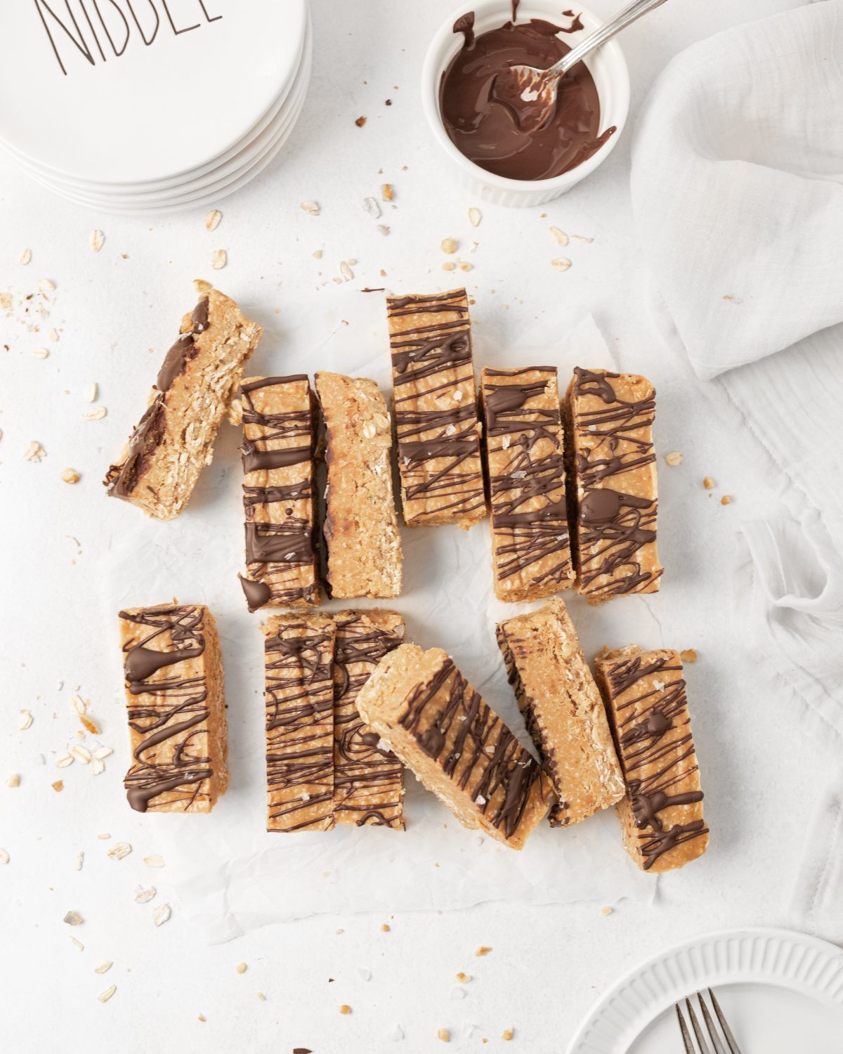 Peanut Butter Oat Protein Bars cut on parchment paper.