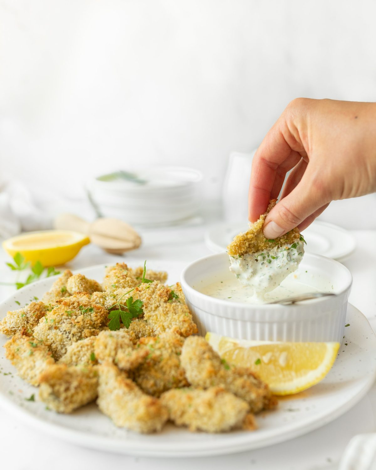 Crispy Oven-baked Artichoke Hearts plated and dipped into Lemon Herb Dip.