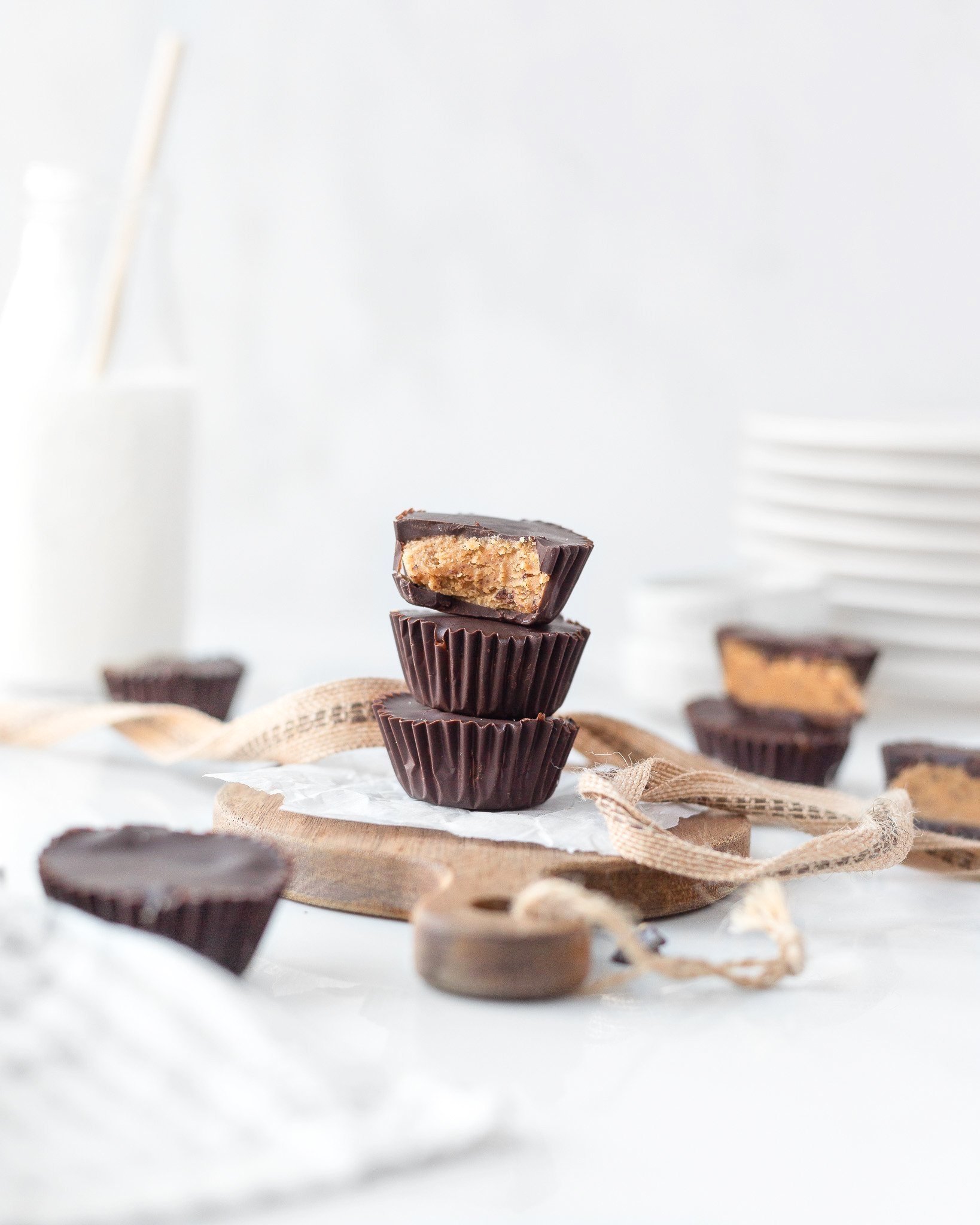 3 Gluten Free Chocolate Cookie Butter Cups stacked on top of each other on parchment paper.