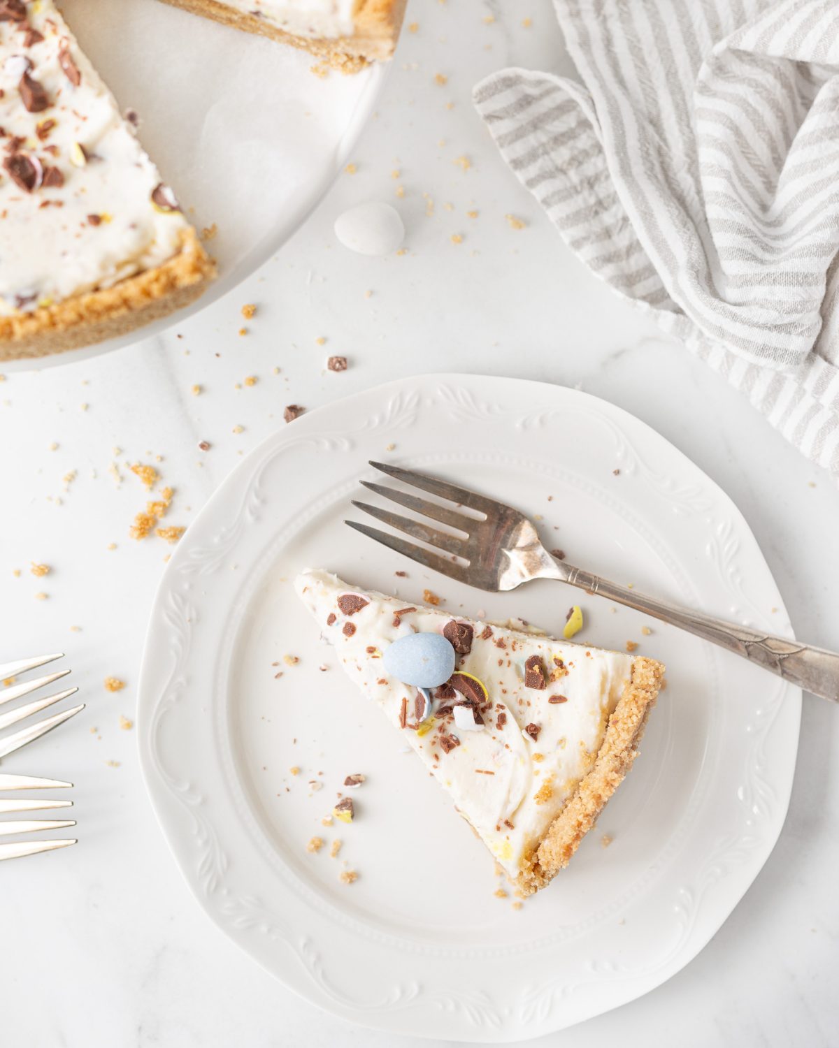 A slice of Gluten Free No Bake Mini Egg Cheesecake on a small plate.