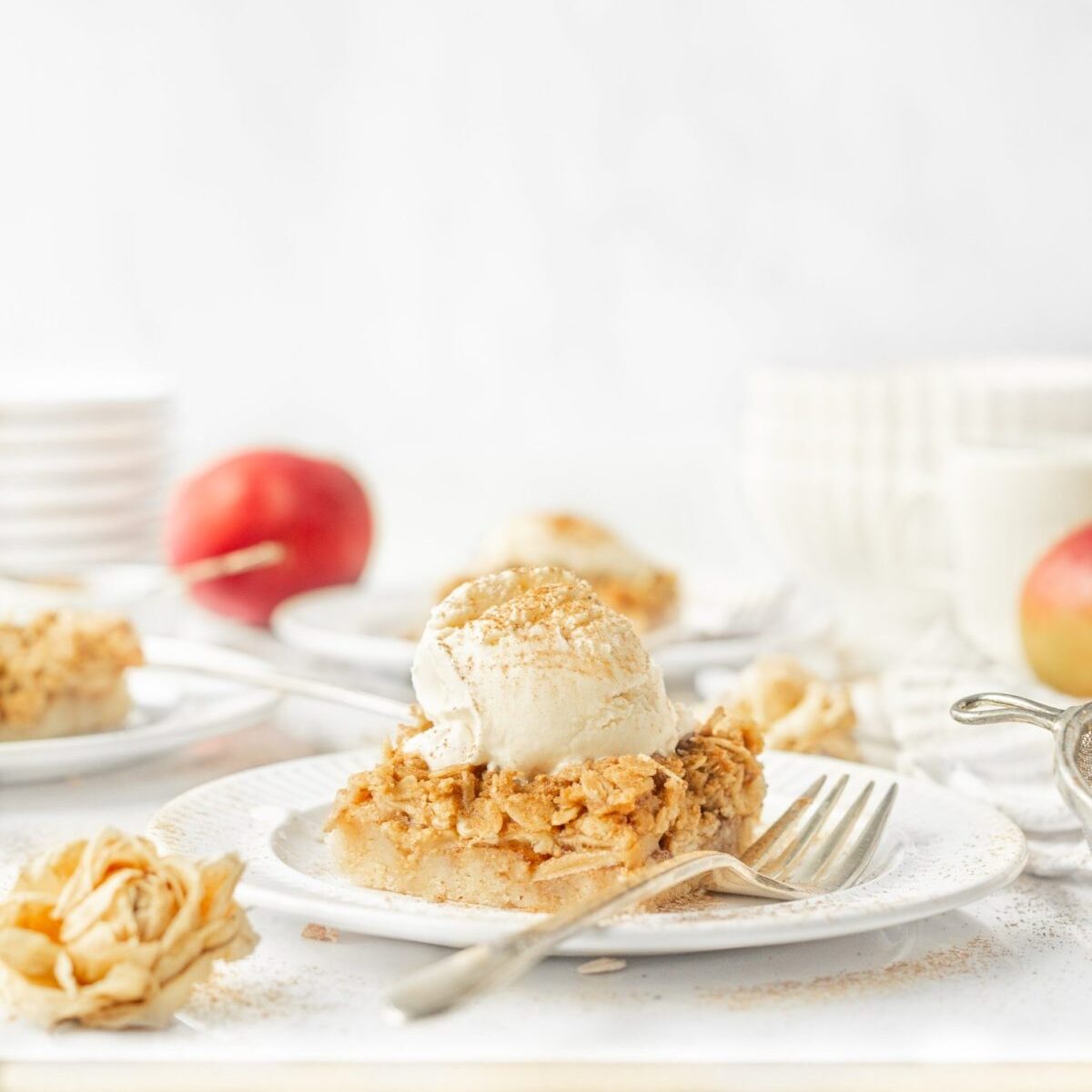 Gluten Free Apple Crumble Bars plated with ice cream on top.