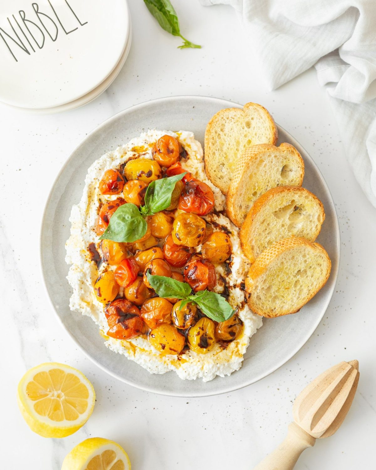 Whipped Ricotta with Roasted Tomatoes and Basil plated.
