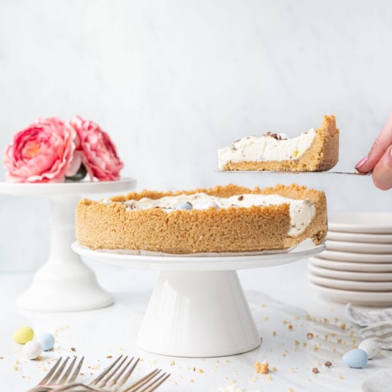 GF No Bake Mini Egg Cheesecake displayed on a cake stand.