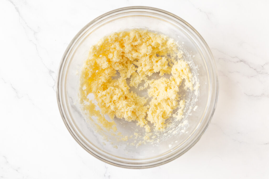 Process shot #2: Softened butter, sugar and vanilla extract mixed in a glass mixing bowl. 