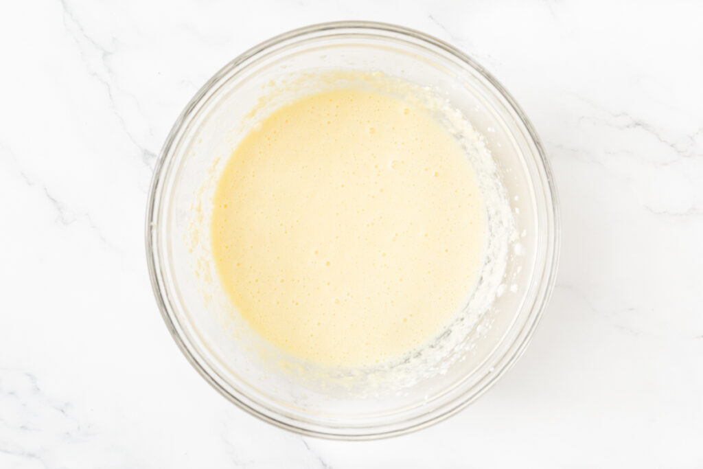 Process shot #3: Egg, yogurt and milk added to the same mixing bowl to complete the gluten free cake batter. It is all mixed together. 