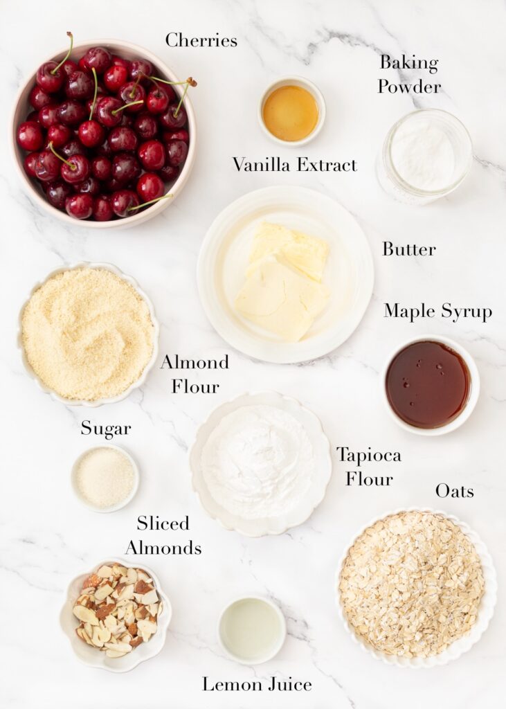 Ingredients for Gluten Free Cherry Crumble Bars portioned out on a marble slab.