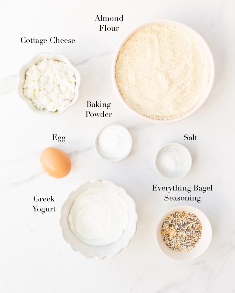 Ingredients for Almond Flour Greek Yogurt Bagels portioned out on a marble slab.