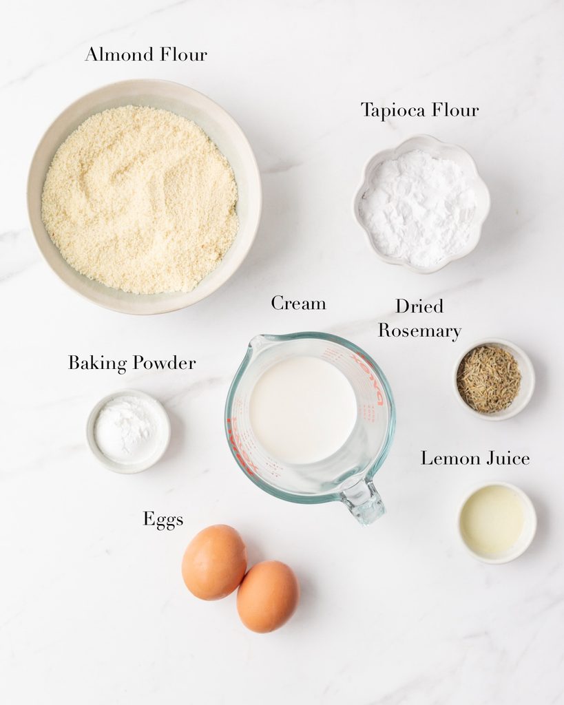 Ingredients for Almond Flour Biscuits portioned out in bowls on a marble slab. 