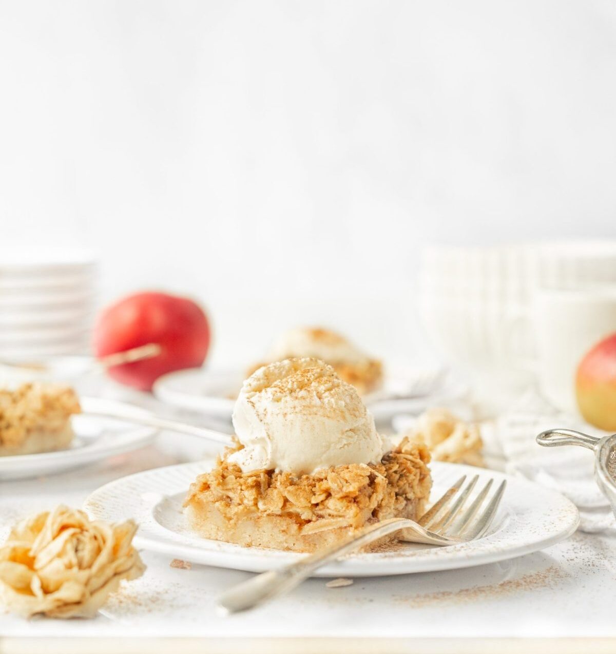 Gluten Free Apple Crumble Bars plated with ice cream on top.